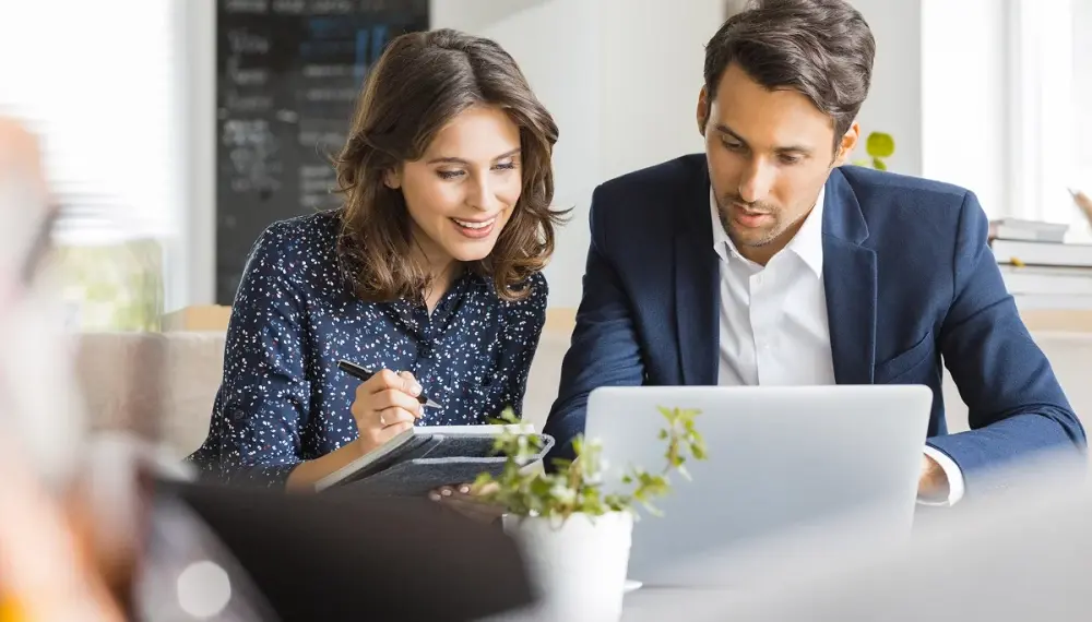 female male colleagues laptop meeting