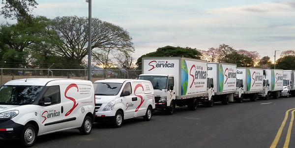 GrupoServica delivery trucks lined up on street