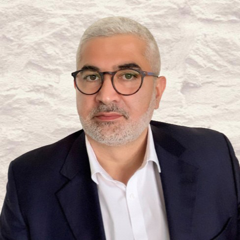 bearded man with glasses suit jacket