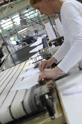 clothing maker working with textiles at a factory