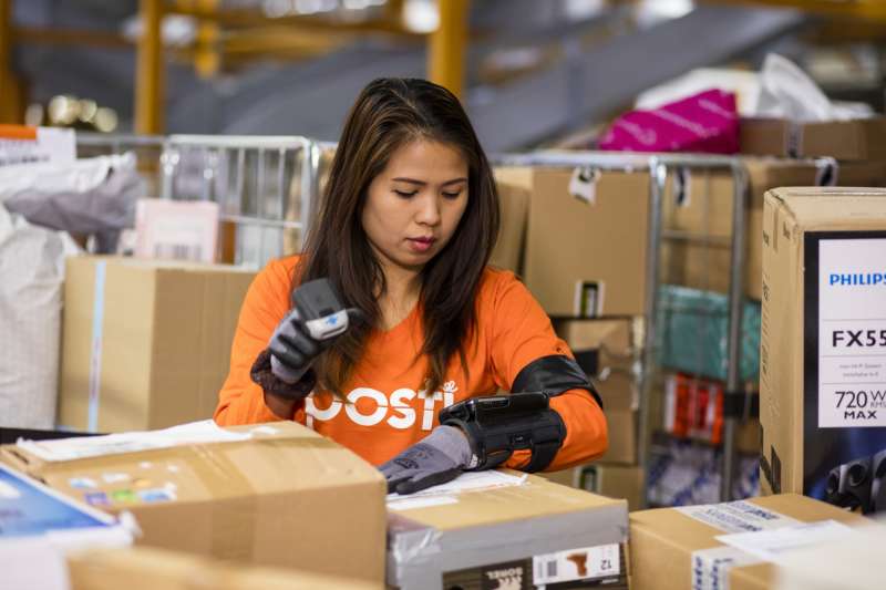 Woman scanning mail in Posti warehouse