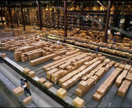 Overhead view of boxes being sorted in large warehouse facility using distribution management systems 