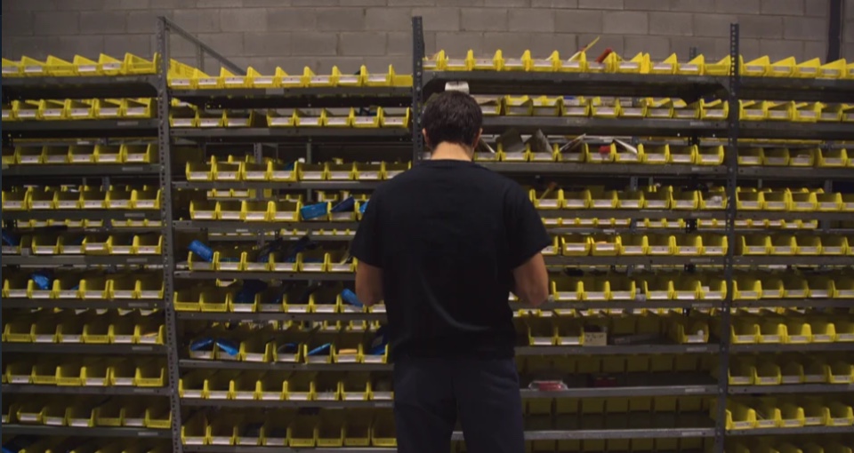 worker sorting through products