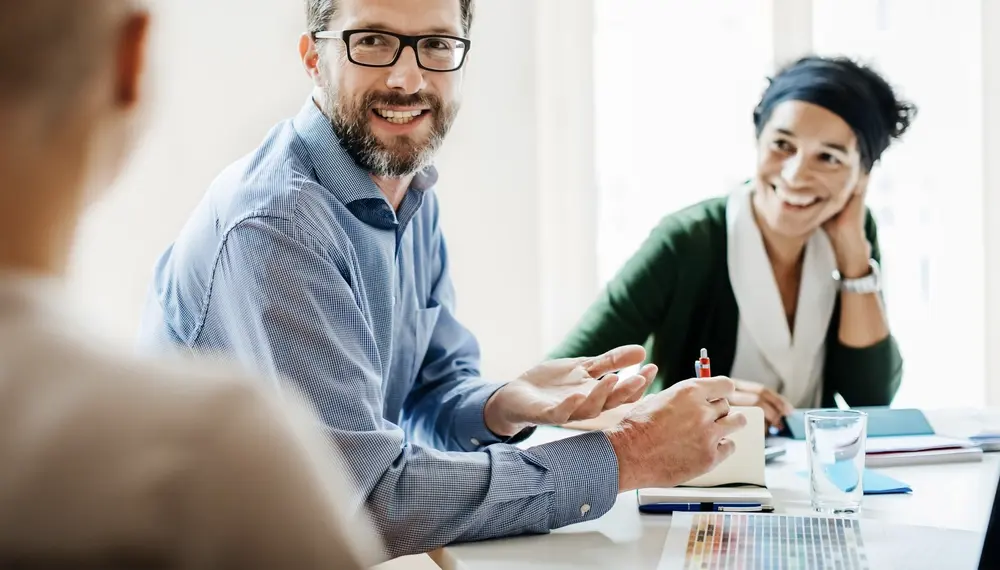 Businesspeople using AI-powered software in a meeting