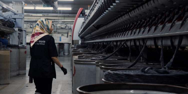 interior photo of a worker at a recycling plant