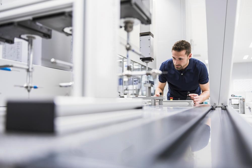 Technician using smart manufacturing machinery 