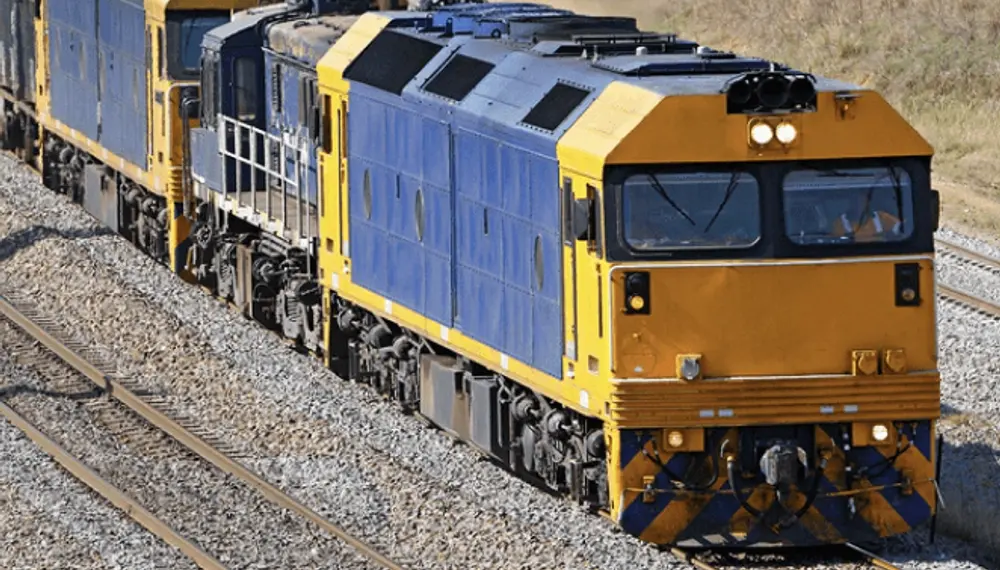 An image of loaded train containers and an electric locomotive