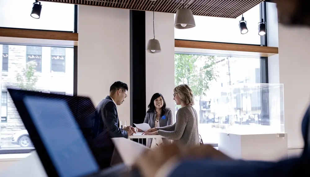 Colleagues meeting around a table in a bright office