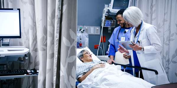 healthcare doctor nurse talking patient   hospital bed  