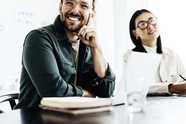 Business man representing an Infor Industry AI customer, listening during a meeting