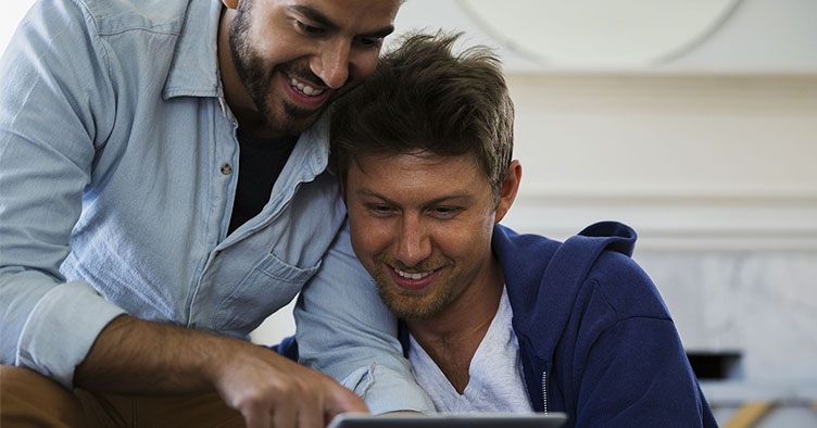 smiling couple using tablet