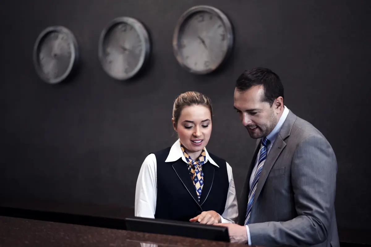 Two coworkers in the hospitality industry going over hotel business analytics