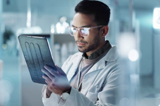 Physician reviewing clinical data on a tablet 