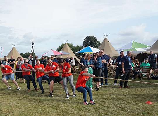 nfor team leans in to tug-a-war competition.