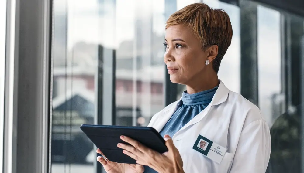 Thinking woman and doctor with tablet in healthcare for search, medical info and results
