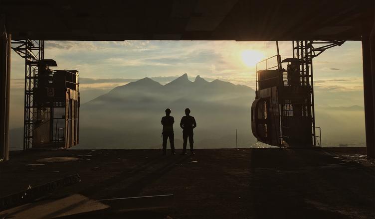 People in a mine looking at the sunset