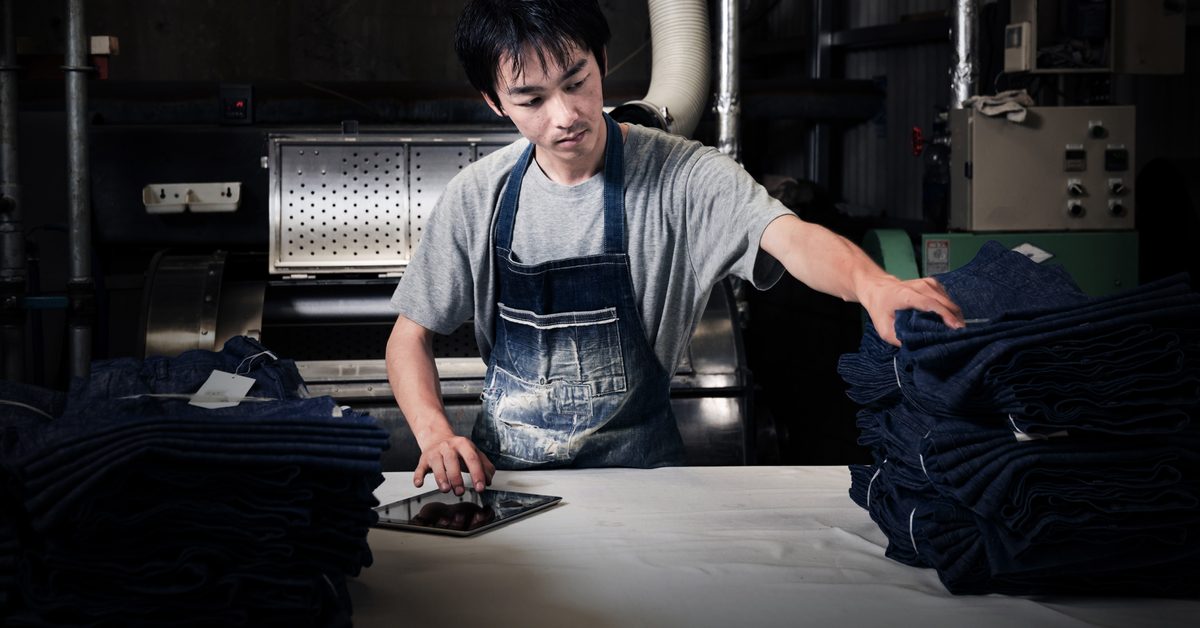 Textile industry worker checking inventory with digital tablet