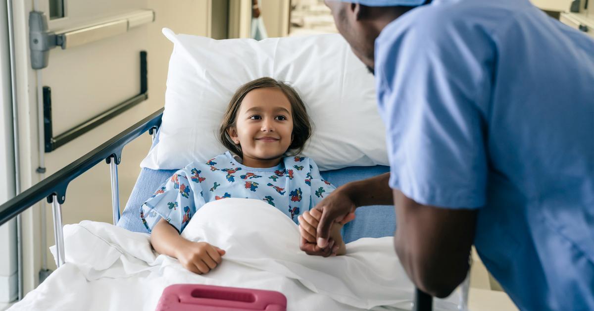 African American male nurse child patient hospital bed hallway