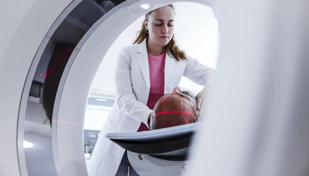 Technician helping a patient in an MRI machine 