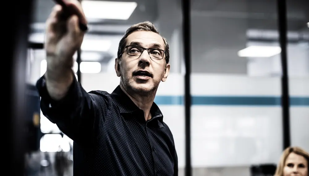 Businessman giving presentation during meeting in office