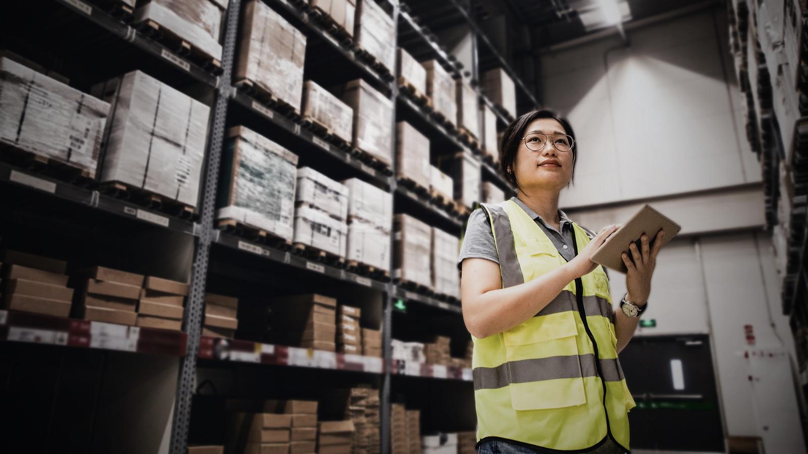 Worker using GenAI on a tablet in a warehouse