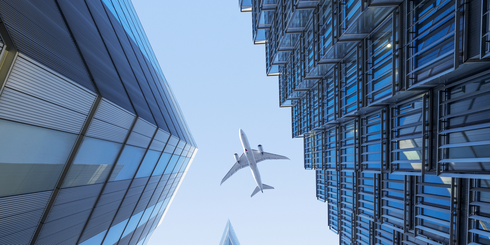 1405816204_airplane-flying-over-buildings-AD_Getty