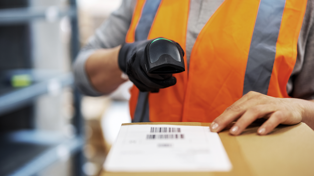 Warehouse worker scanning a package with a barcode scanner