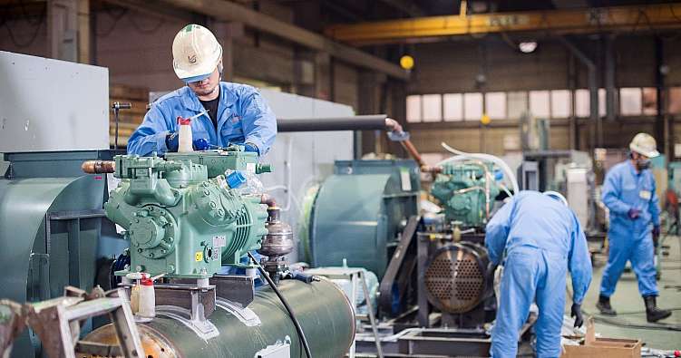 Man working on air-conditioning units in the Ushio Reinetsu Co. Ltd. factory