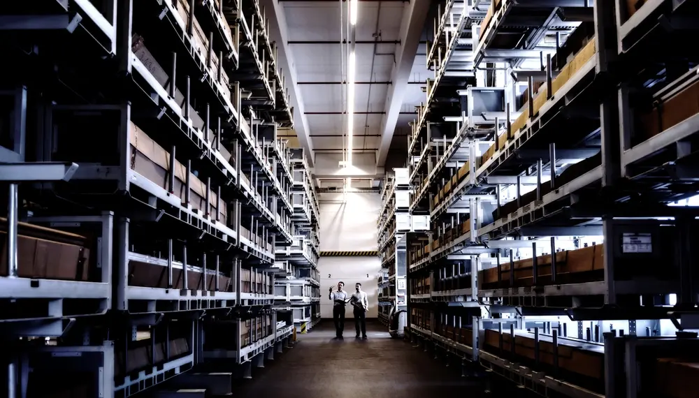 Two men walking in factory warehouse