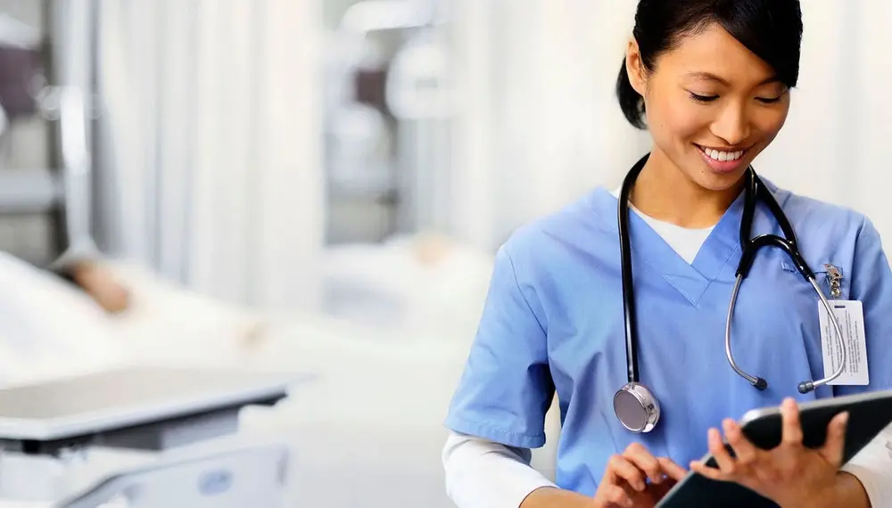 Nurse working in the hospital using enterprise software solutions on a tablet
