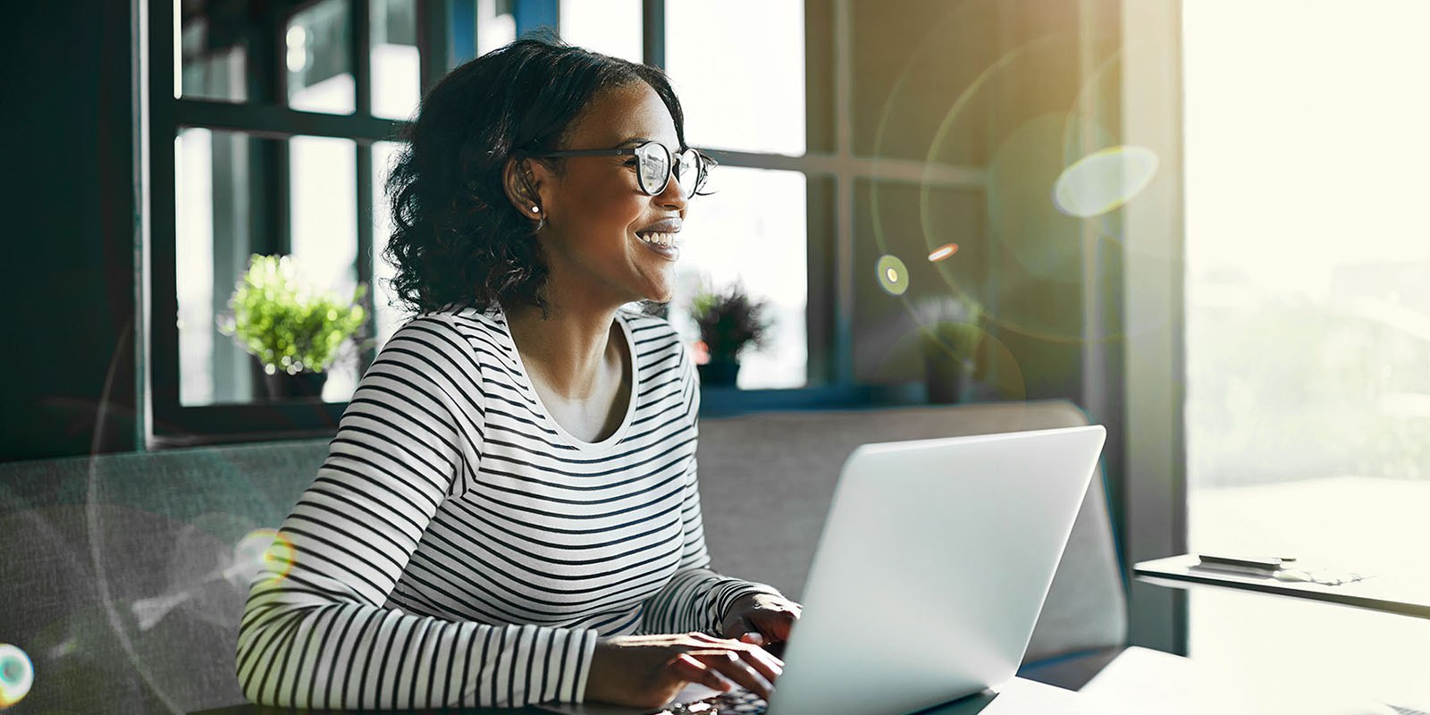 smiling young African woman working online