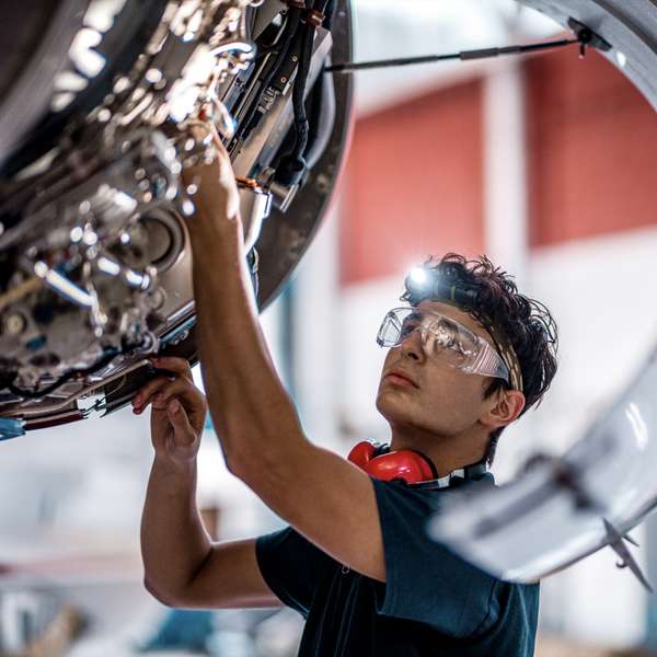 Aerospace engineer inspecting and servicing equipment 