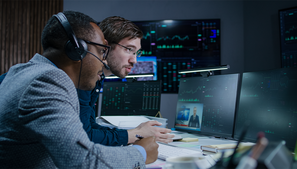 Two men looking at a computer screen