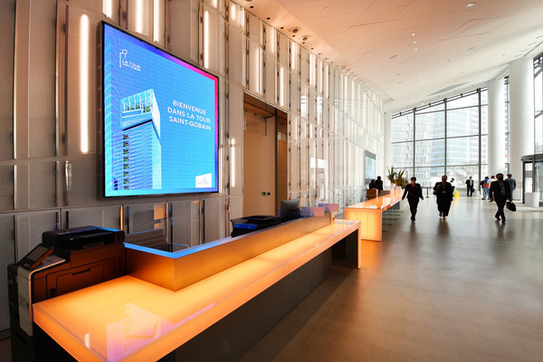 glass-walled office lobby people walking