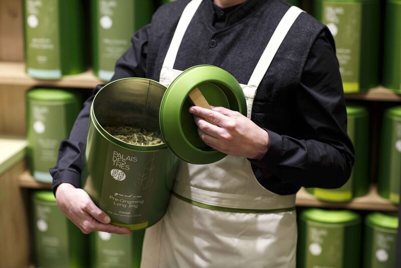 Palais de Thes tea canisters shelves person holding canister