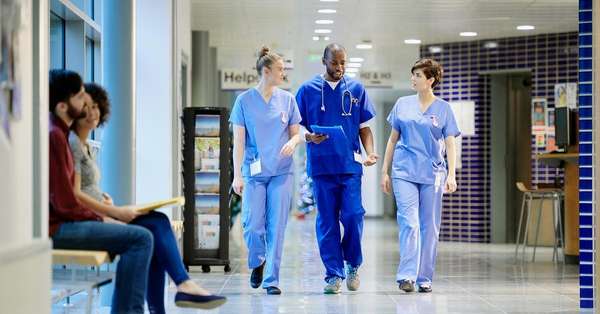doctor nurse walking hospital corridor