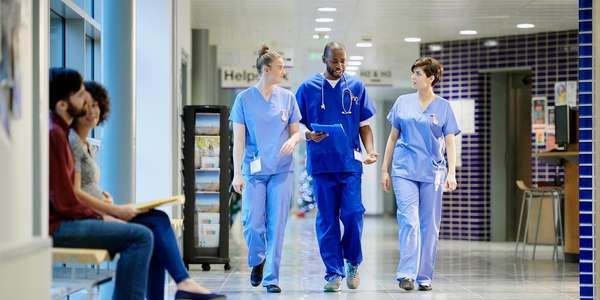 doctor nurse walking hospital corridor