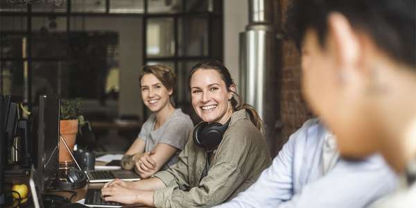 female smiling at her colleague