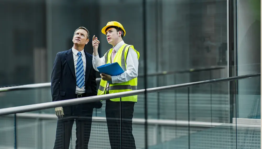 Male finance director and male engineer in conversation