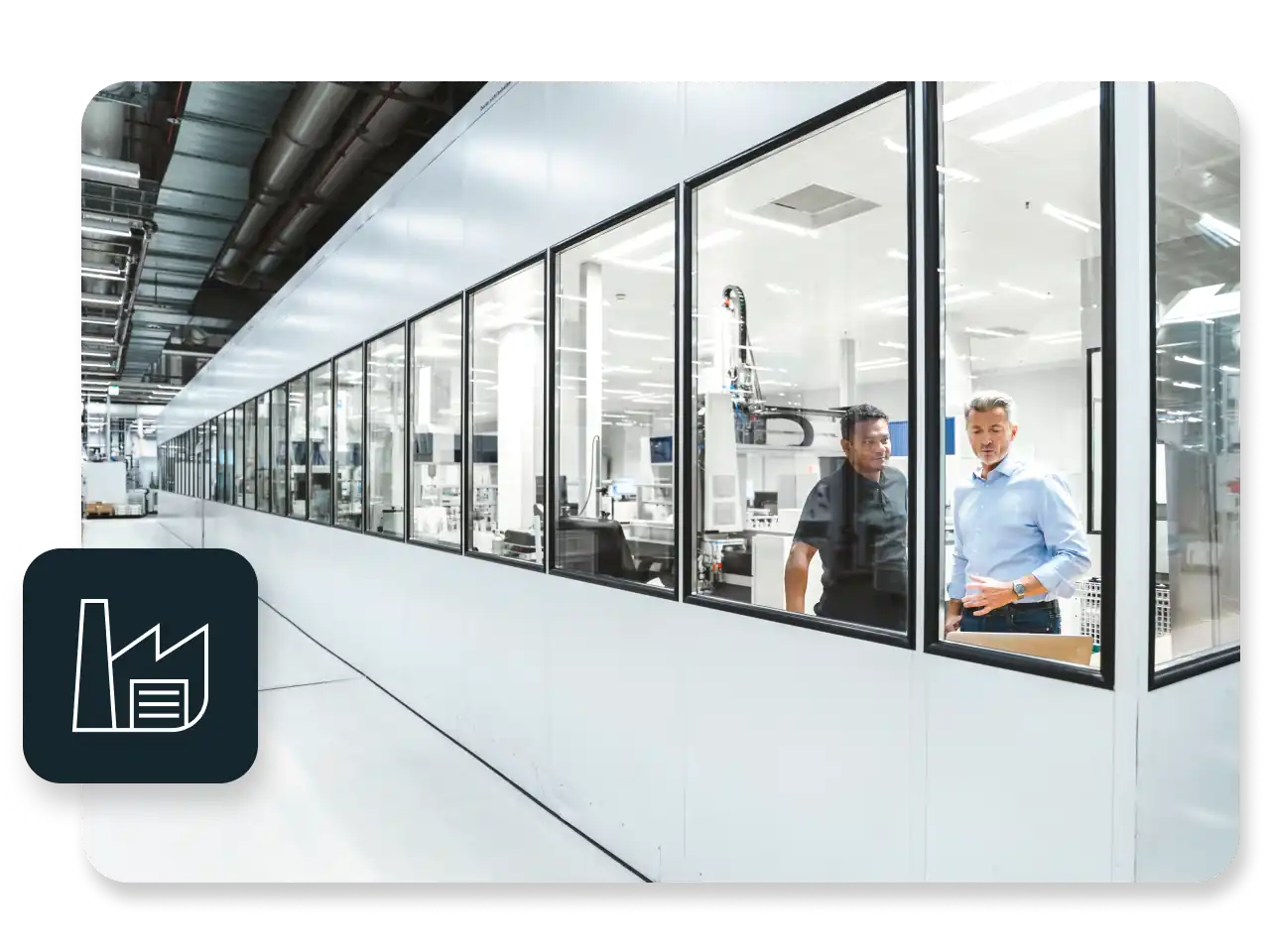 Engineers in a control booth on a factory floor