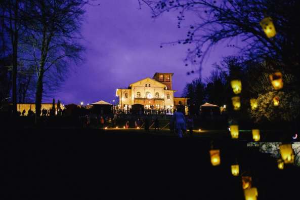 photo of a villa at night with lights in a tree