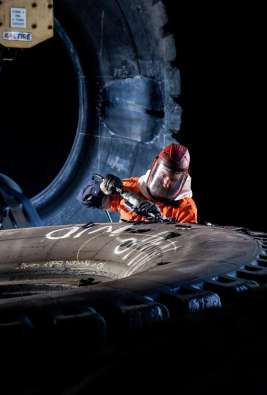 Man working on a giant tyre