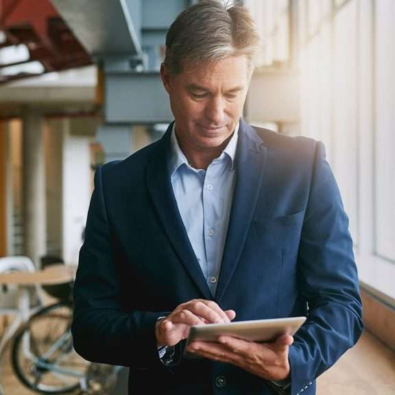 male professional looking at a device