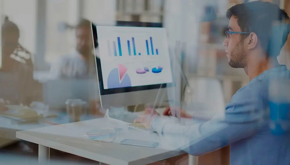 Businessman running hospitality analytics and insights on his laptop