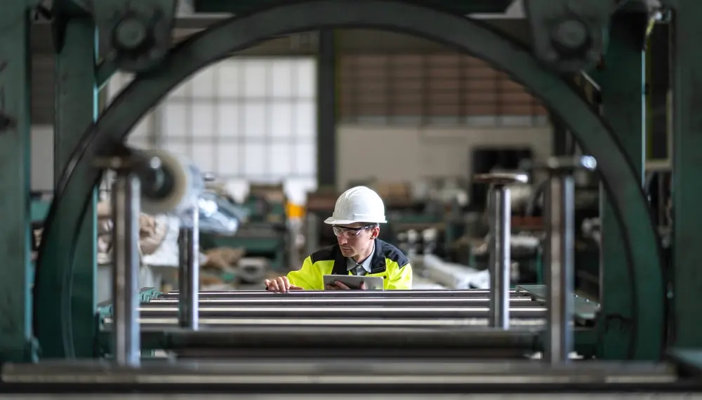 Engineer inspecting equipment in a factory 