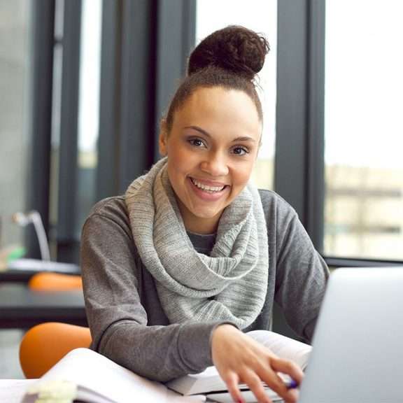 Young woman sitting on her computer