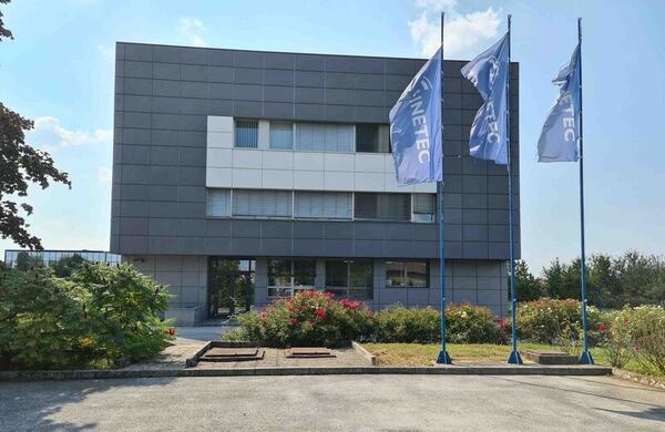 office building exterior with flags and parking lot