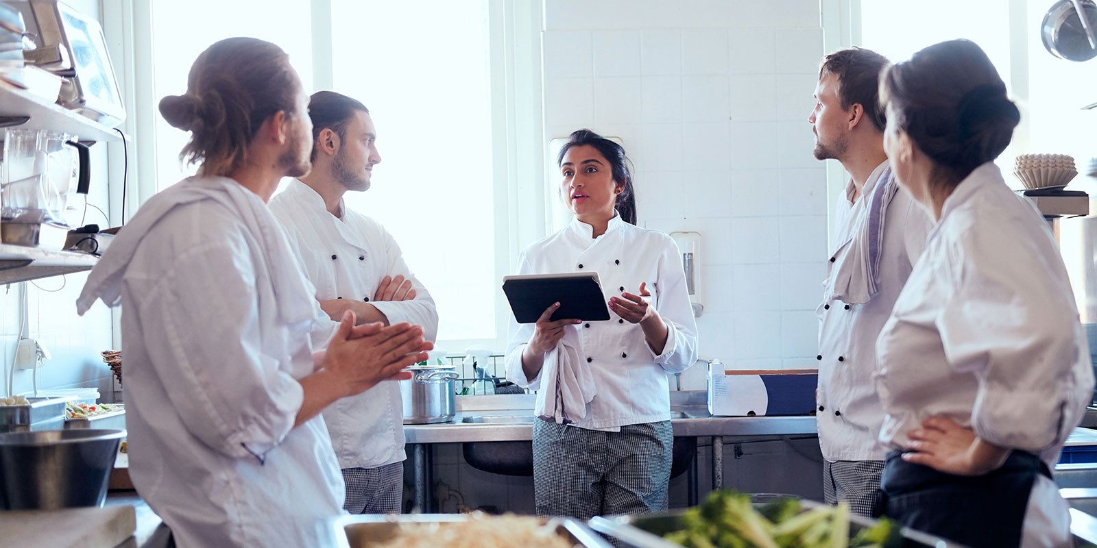 Sales and catering team collaborating in the kitchen with sales and catering software.