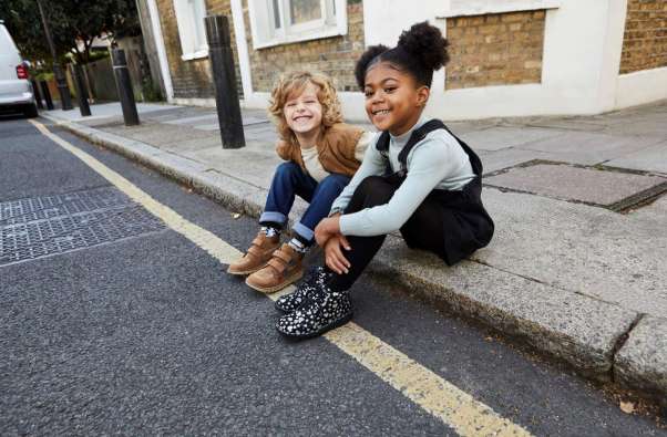 Kids sitting on the curb