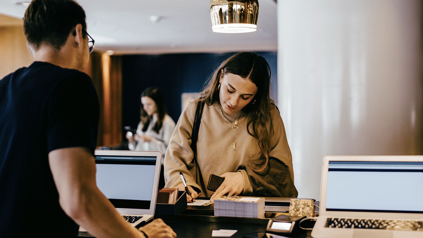 hotel receptionist helping a customer